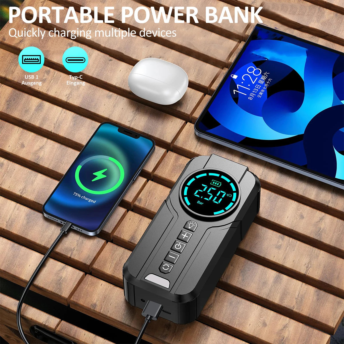 Compact Jump Starter Kit charging a smartphone, tablet and wireless earbuds via USB and Type-C output on a wooden table