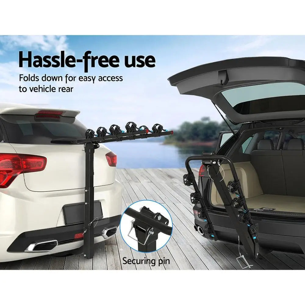 Foldable 4-Bike Hitch Rack mounted on the rear of an SUV and folded down for boot access, with securing pin close-up