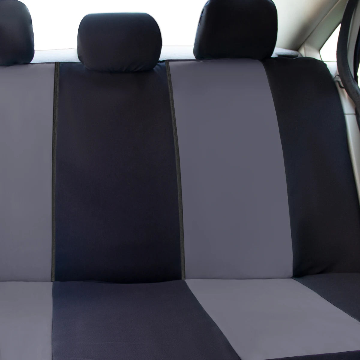 Gray car seat covers with black accents on a vehicle interior