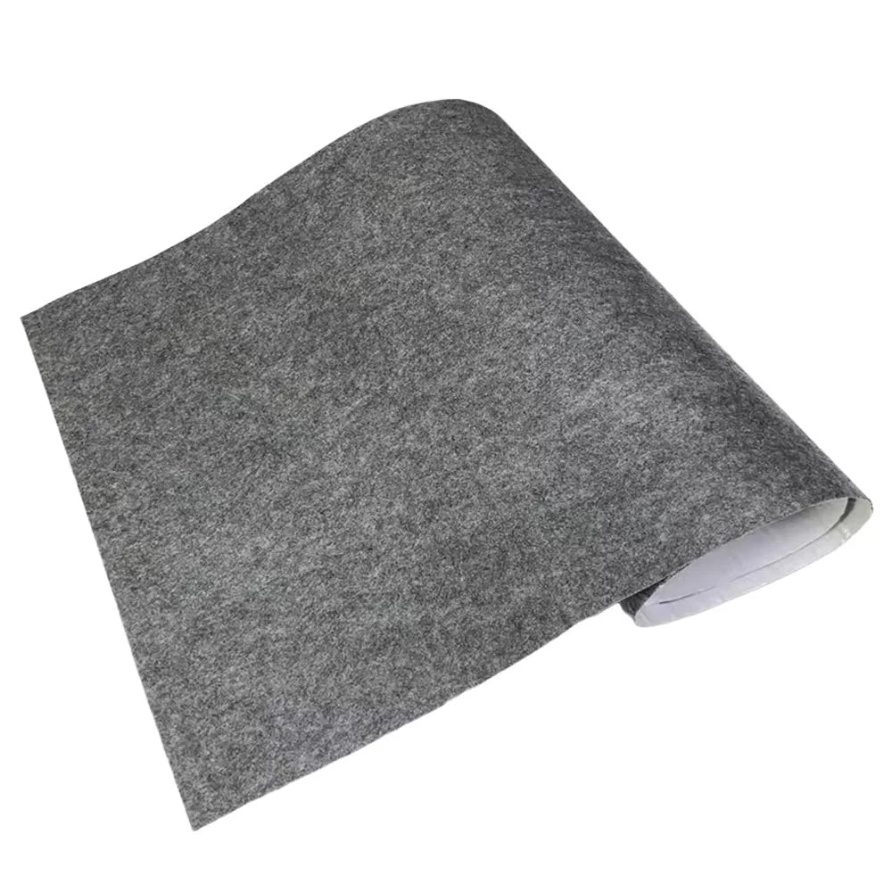 Mid grey self-adhesive felt lining sheet rolled at one end on a white background