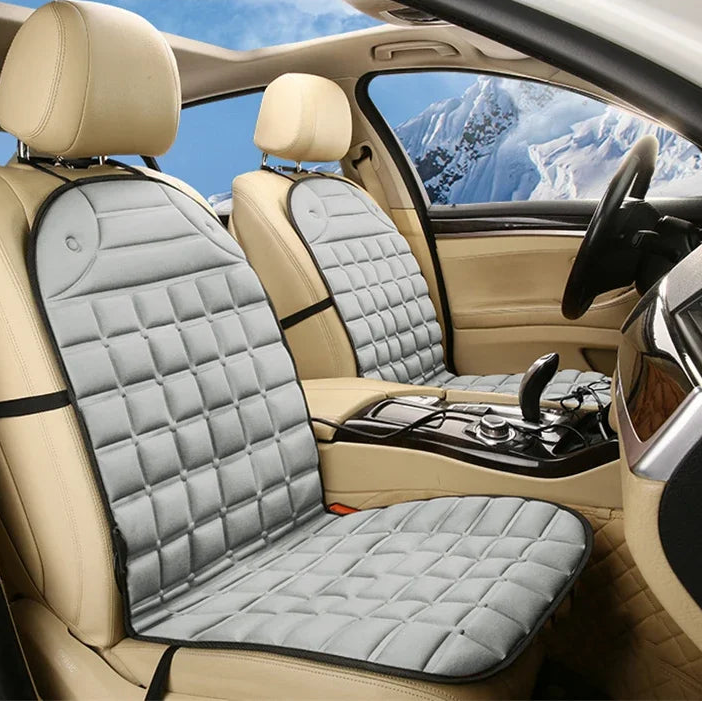Grey 12V Heated Car Seat Cushion fitted to a car's front seats with a snowy mountain view through the window