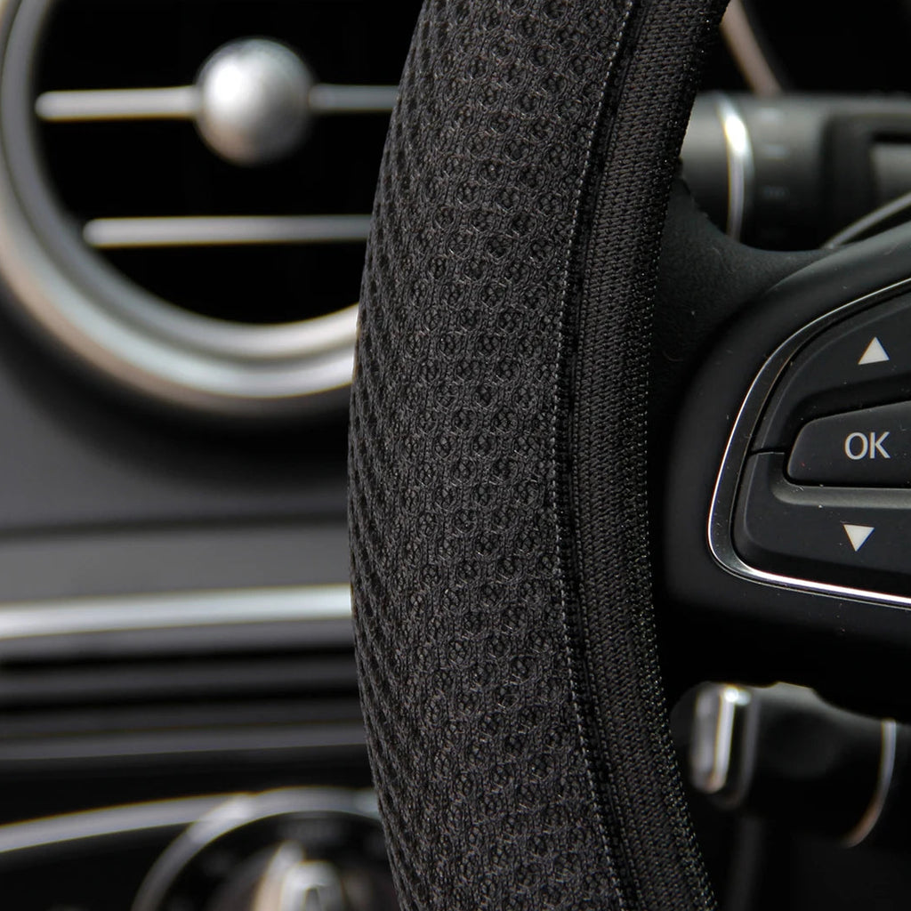 Close-up of black mesh steering wheel cover fabric texture showing breathable all-season grip