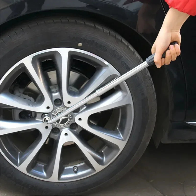 Telescoping lug wrench being used on a Mercedes-Benz alloy wheel to loosen a wheel nut