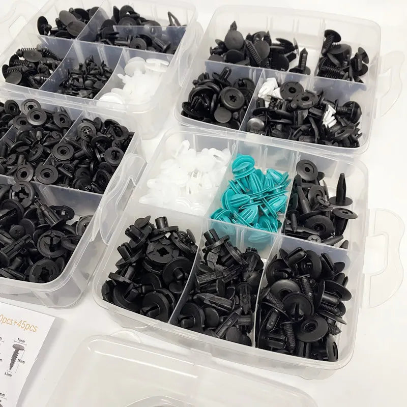Close-up of black and teal automotive fastener clips neatly organised into storage case compartments