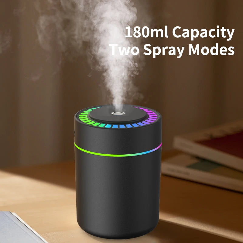 Black car aroma diffuser emitting mist on a desk, 180ml capacity with two spray modes
