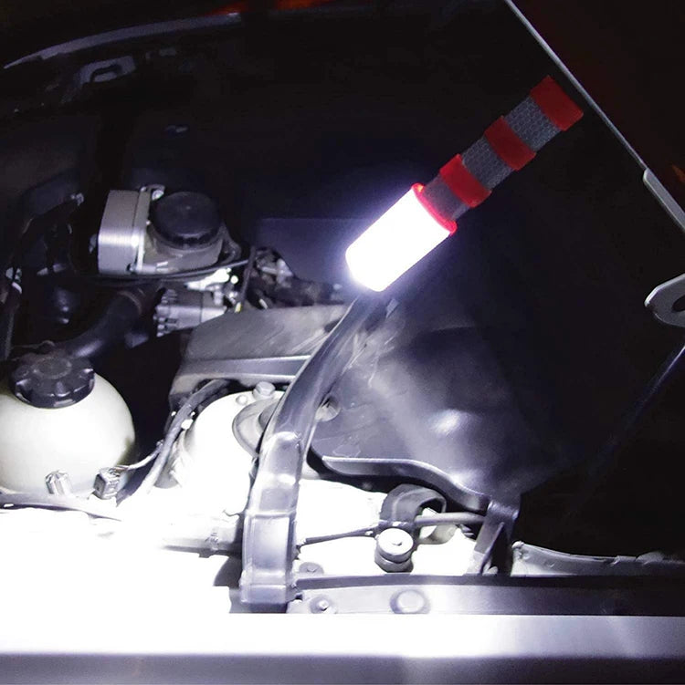 Magnetic LED Warning Beacon clipped to an open car bonnet, used as a work light at night