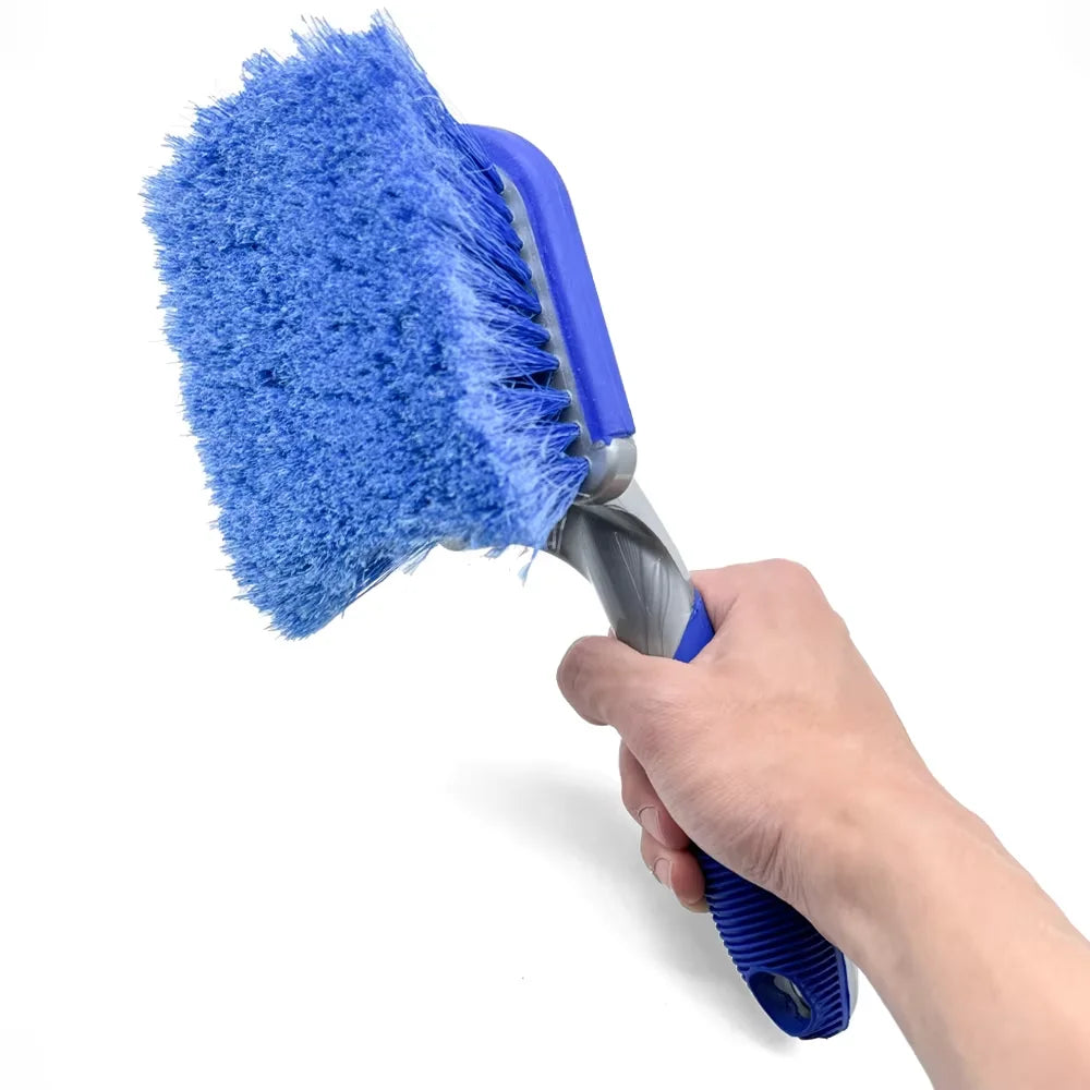Close-up of a tyre detailing brush with dense blue bristles and a curved non-slip handle