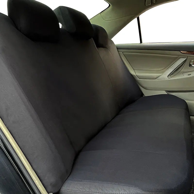Black Breathable Mesh Seat Cover installed on rear bench seat viewed from behind headrests inside car cabin