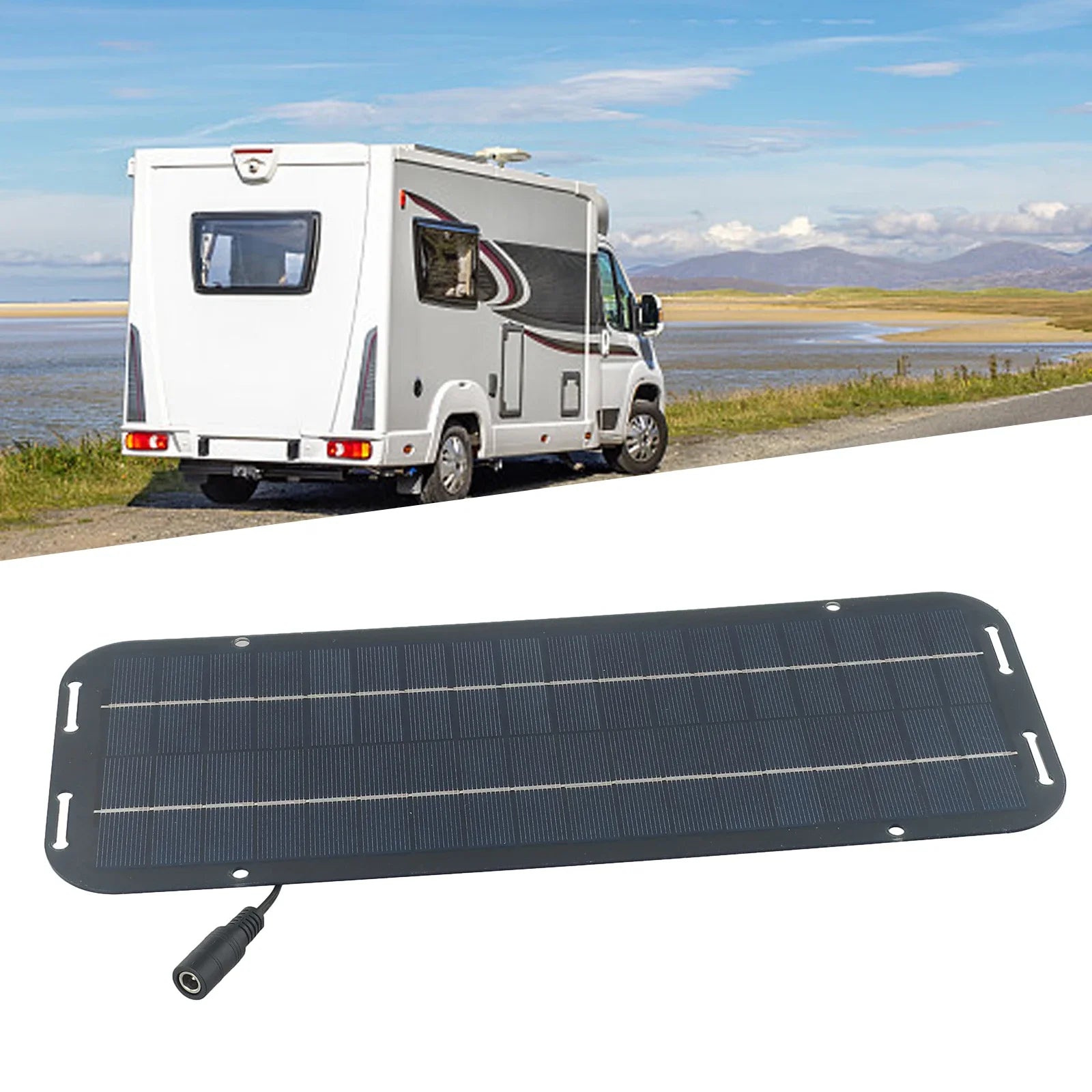 Solar battery trickle charger panel with accessories in front of a motorhome parked near a coastal road