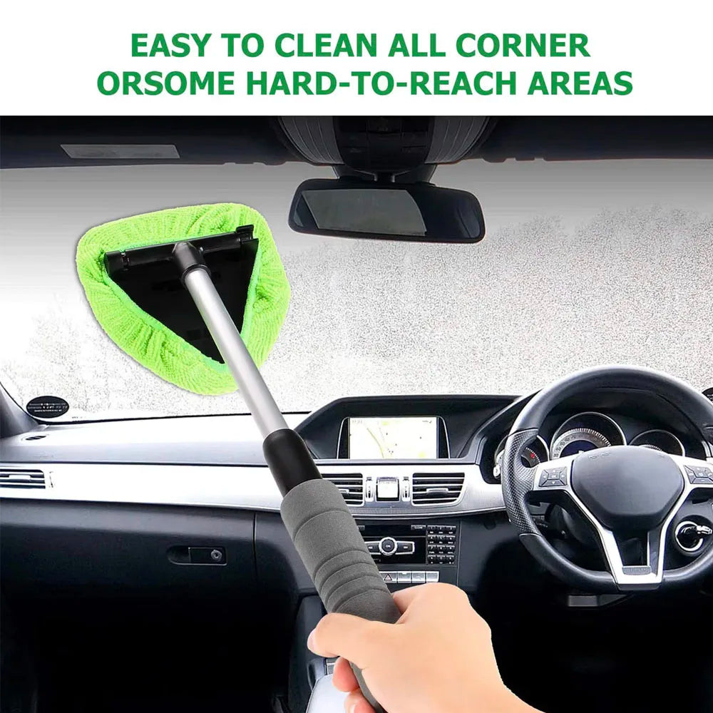Telescopic car window cleaning brush reaching into corners of a car windscreen from inside the vehicle
