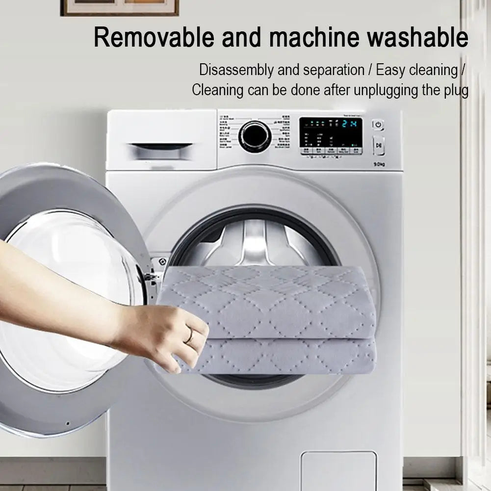 Hand placing the removable Heated Travel Car Blanket into a washing machine to demonstrate it is machine washable