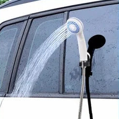 Rechargeable Camp Shower Kit head mounted on a car window spraying water for outdoor rinsing