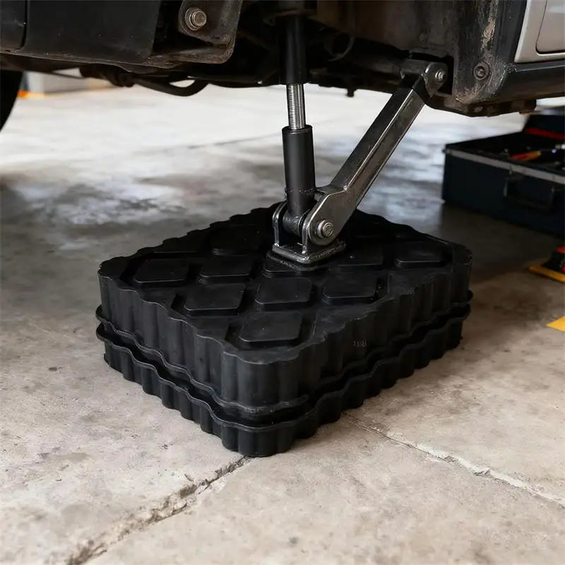 Heavy-Duty Jack Pad fitted under a hydraulic trolley jack lifting a car in a home garage