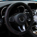 Black PU leather steering wheel cover with red stitching fitted to a car steering wheel with multifunction buttons