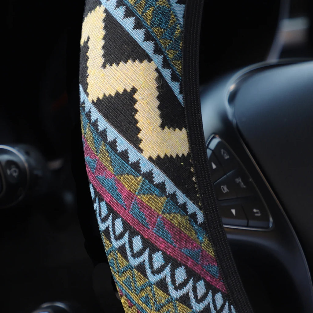Close-up of the tribal geometric pattern weave on the bohemian linen steering wheel cover fitted to a steering wheel