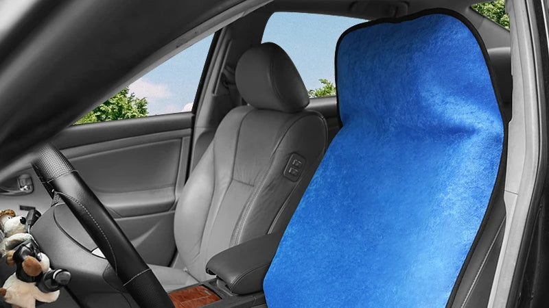Car interior with a blue seat cover on the driver's seat