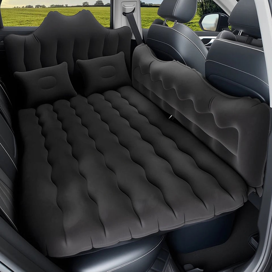 Black Back Seat Air Mattress inflated across a car's rear seat with two pillows, creating a flat sleeping surface
