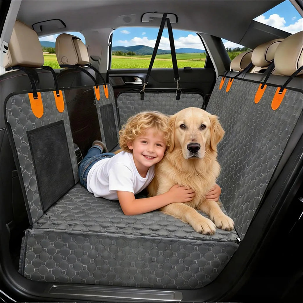 Smiling boy and golden retriever lying together on the Washable Dog Seat Extender in a car back seat