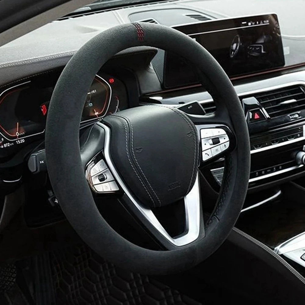 Black Steering Wheel Cover and Non-Slip Suede Grip Cover fitted to a steering wheel inside a car interior.