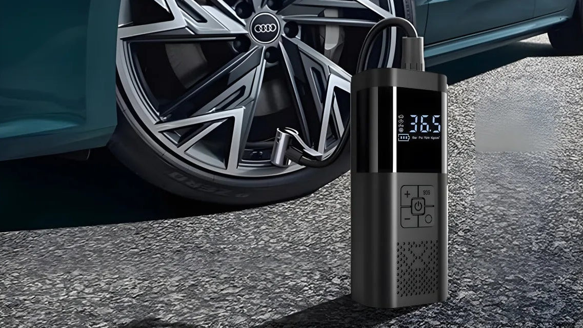 Cordless Digital Tyre Inflator with hose connected to a car's alloy wheel valve, LCD display reading 36.5 PSI