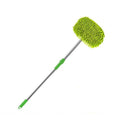 Green microfiber cleaning brush with extendable handle on a white background