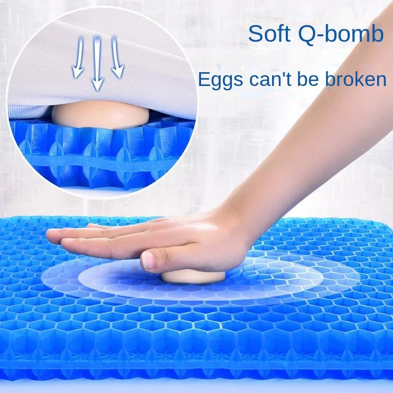 Hand pressing the Gel Seat Cushion with an egg resting on top to demonstrate its unbreakable cushioning support