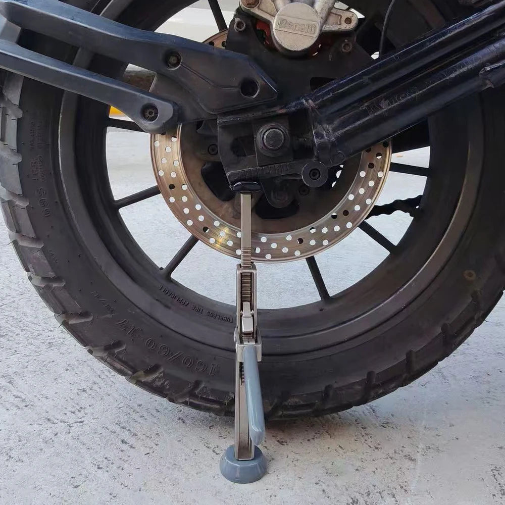 Motorcycle Ratchet Lift Stand supporting a motorcycle's rear wheel and swingarm in a home garage