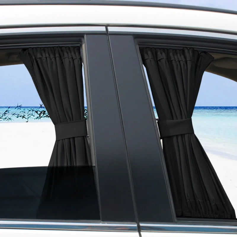 Black Side Window Privacy Curtains tied back on rear car side windows with a beach view outside