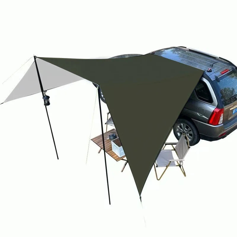 Expedition Side Sunshade tarp attached to a vehicle's roof rack with a camp table and chairs set up in the shade