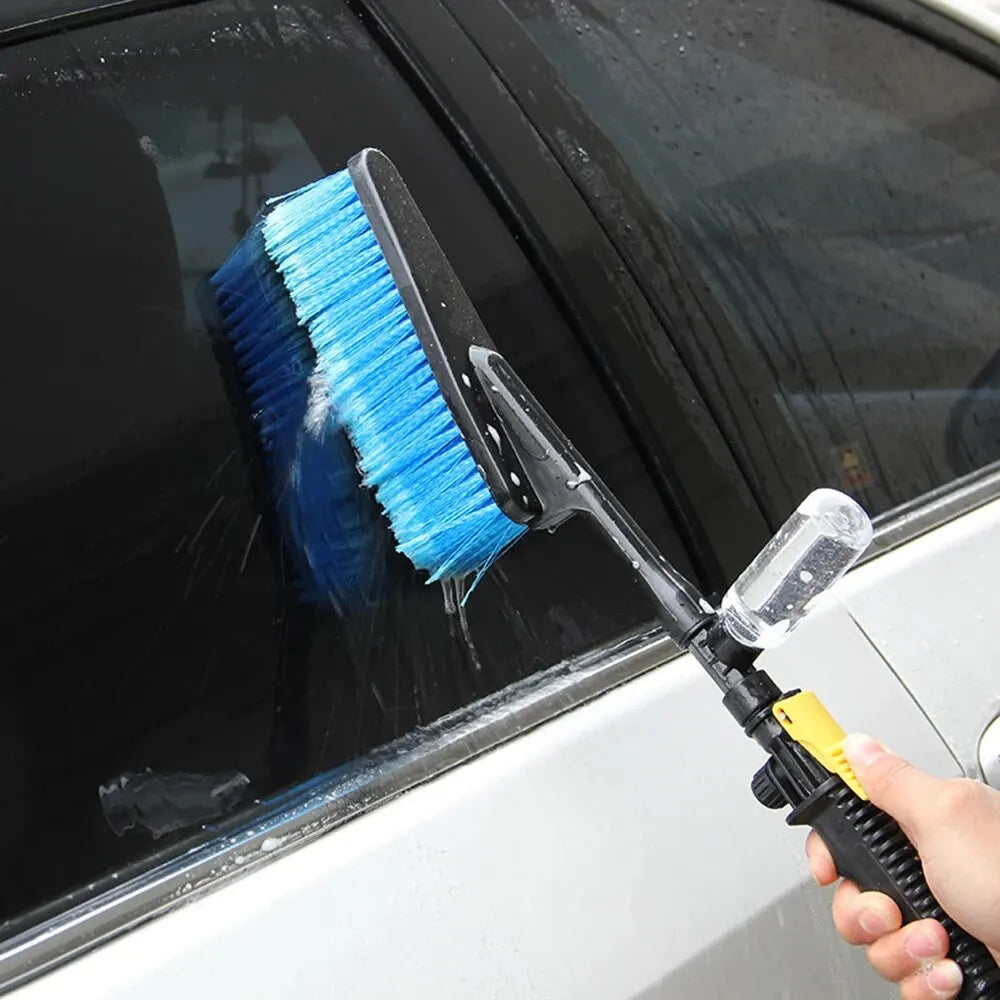 Car Foam Wash Brush being used by hand to clean a car window with foam and water