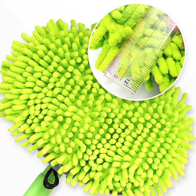 Green cleaning scrubber with close-up of bristles and ruler for scale on a white background