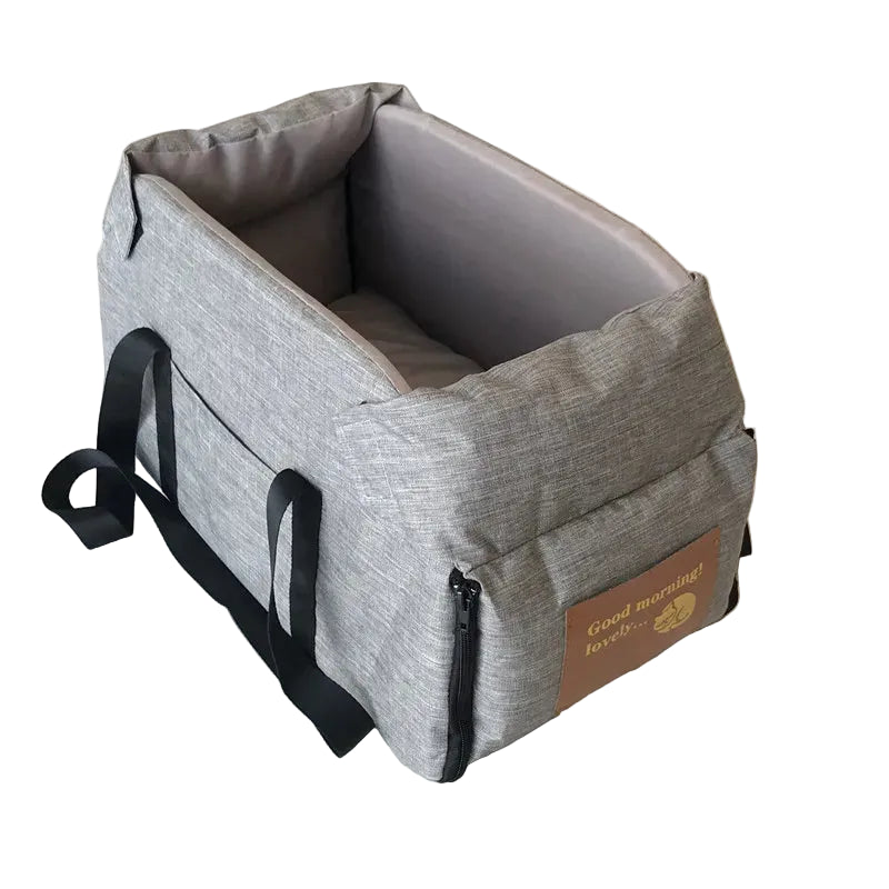 Empty grey console pet booster seat showing padded sides and black carry straps on a tiled floor
