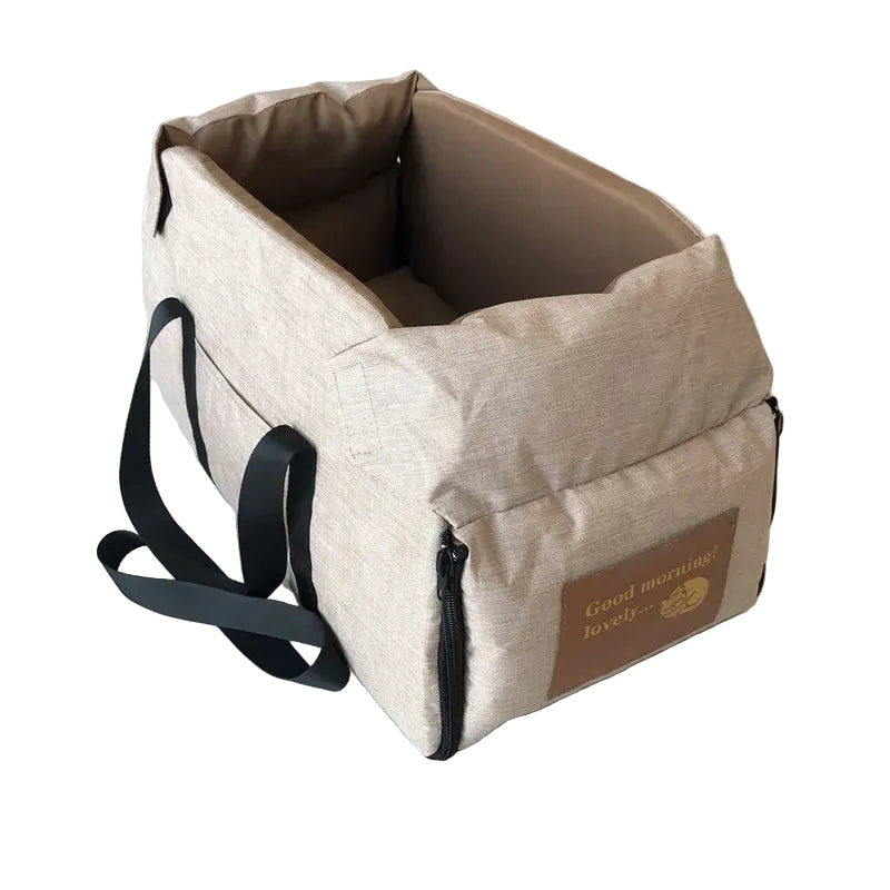 Beige console pet booster seat shown empty, highlighting the padded walls and leather-look brand patch
