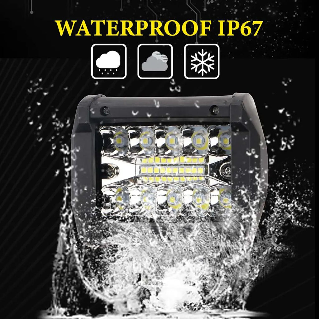 Compact LED Work Light with IP67 waterproof rating being splashed with water on a black background