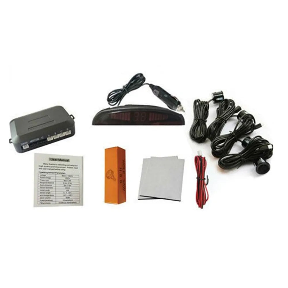 Wireless parking sensor kit box contents including control box, LED display, four sensors with cables, mounting bracket, adhesive pads and user manual