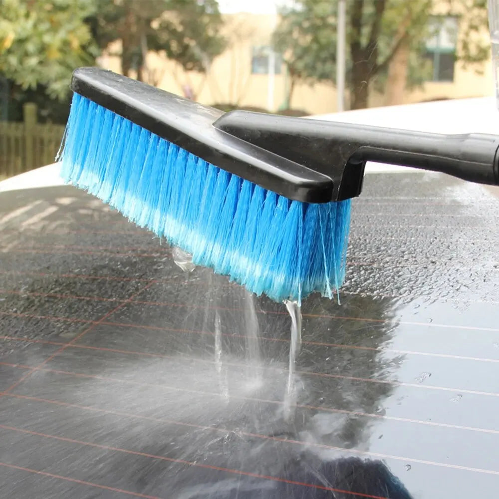 Car Foam Wash Brush spraying a jet of water onto a car roof outdoors