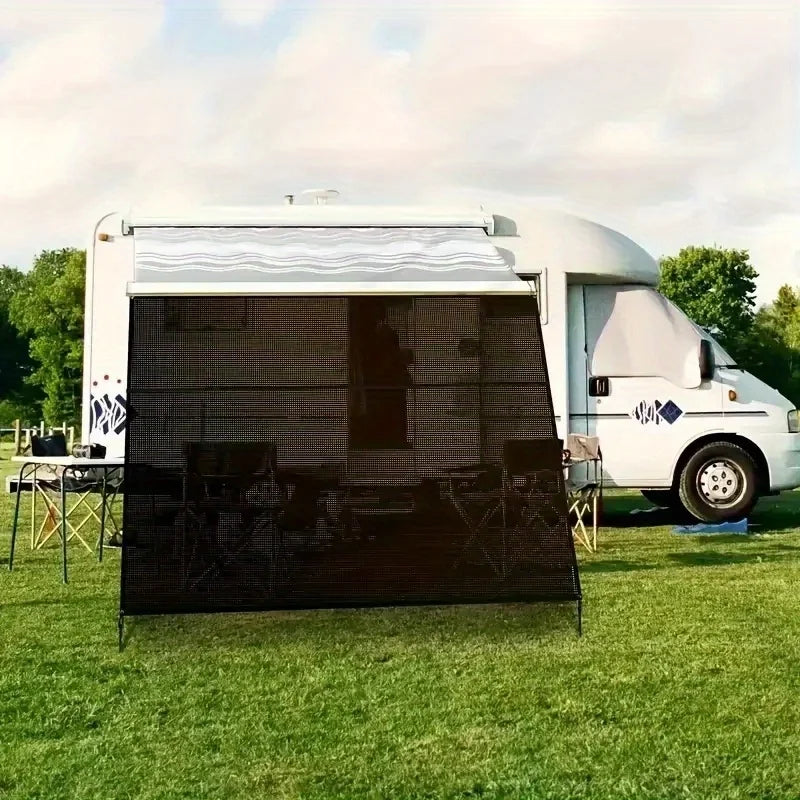 Black HDPE Sun Shade Net hanging as a privacy screen from a motorhome awning, over a table and chairs on a grassy campsite