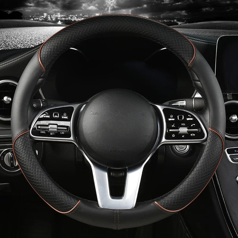 Diamond Leather Steering Wheel Cover in black leather with orange stitching, installed on a steering wheel