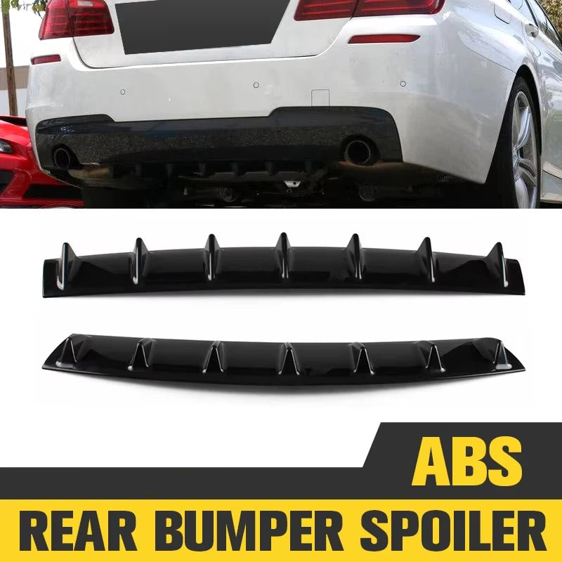 Gloss black ABS shark fin rear diffuser fitted to the rear bumper of a sedan, pictured above two matching diffuser panels on a white background