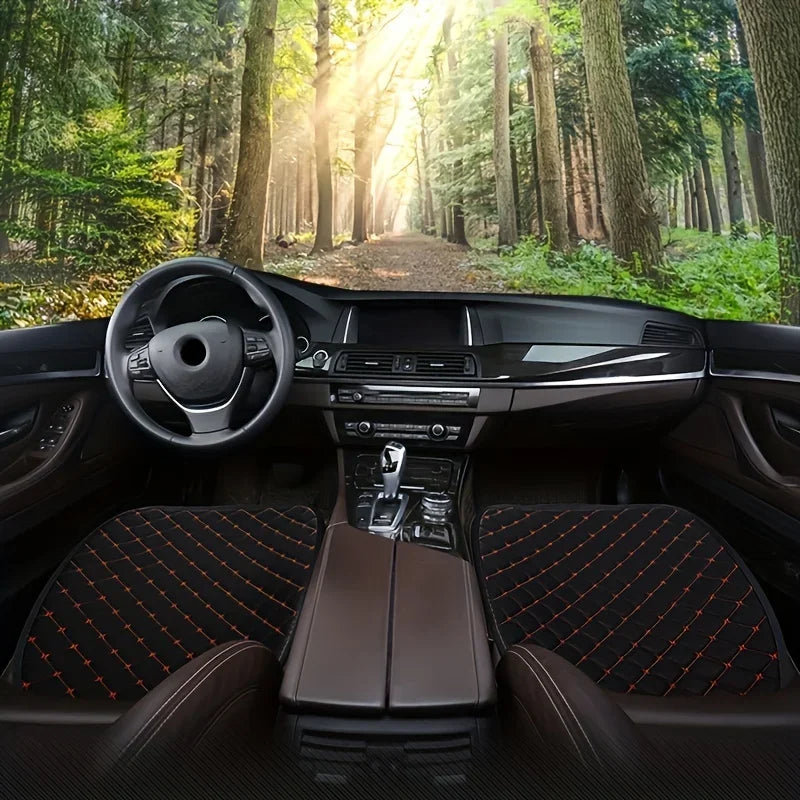 3-Piece Seat Cushion Set fitted to black leather front seats, lifestyle shot with forest scenery through the windscreen
