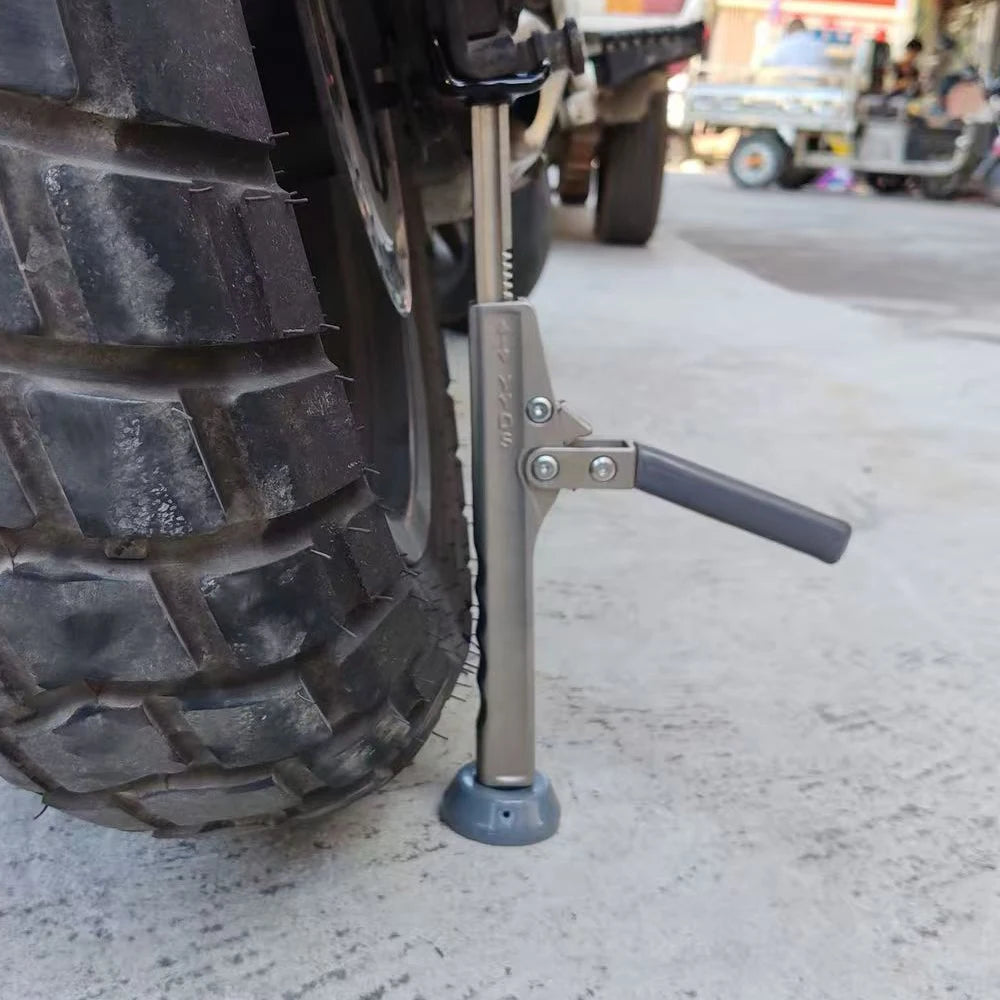 Motorcycle Ratchet Lift Stand supporting a motorcycle's rear tyre on a concrete street