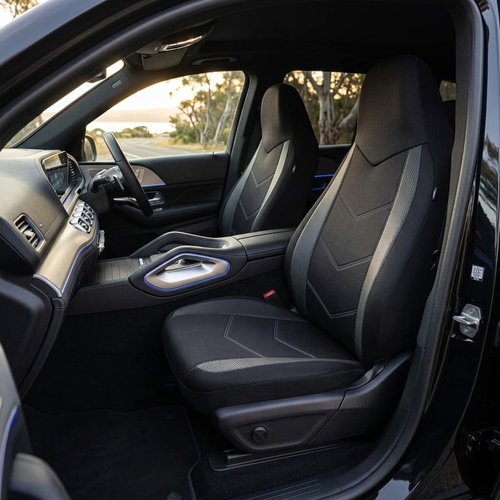 Black and grey Sport Mesh Car Seat Cover fitted to the driver's seat of a right-hand drive car, viewed through the open door