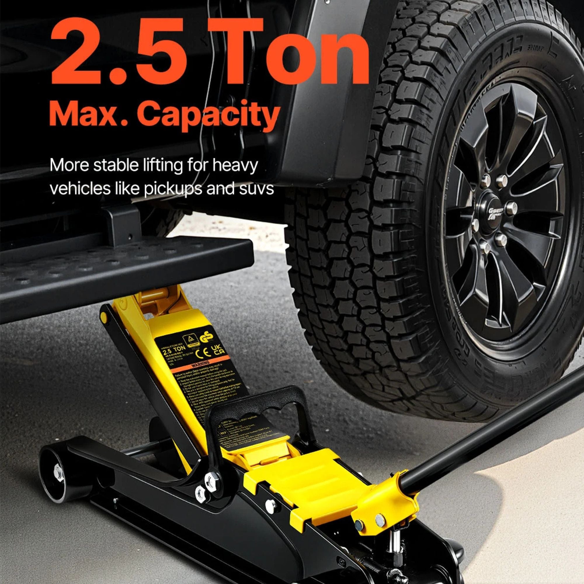 Steel Racing Floor Jack lifting a pickup truck wheel in a dark garage, rated 2.5 tonne max capacity for heavy vehicles like utes and SUVs