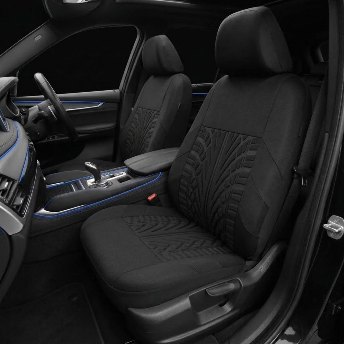 Black car seat covers installed on the front seats of a vehicle interior, featuring textured geometric patterns on the seat backs and seats, shown with blue ambient lighting accents.