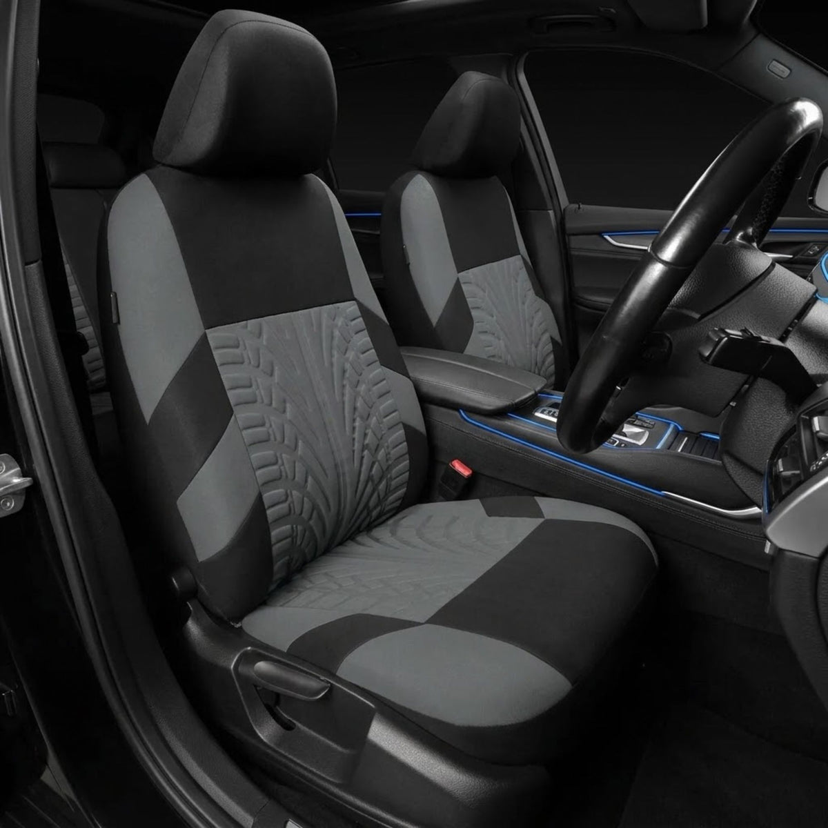 A pair of gray and black car seat covers installed on the front seats of a vehicle interior, featuring quilted and textured panel designs.