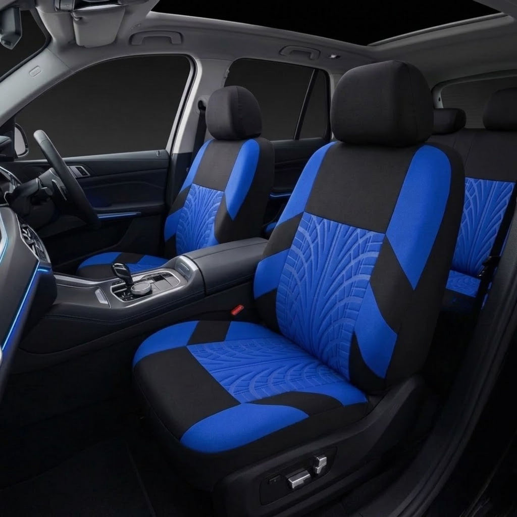 Blue and black car seat covers installed on the front seats of a vehicle interior, showing the patterned fabric on the seat backs and seats.