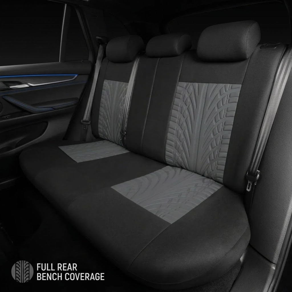 Rear bench car seat covers in black and gray with quilted leaf-patterned center panels, shown installed inside a vehicle. Text at the bottom reads 'FULL REAR BENCH COVERAGE'.