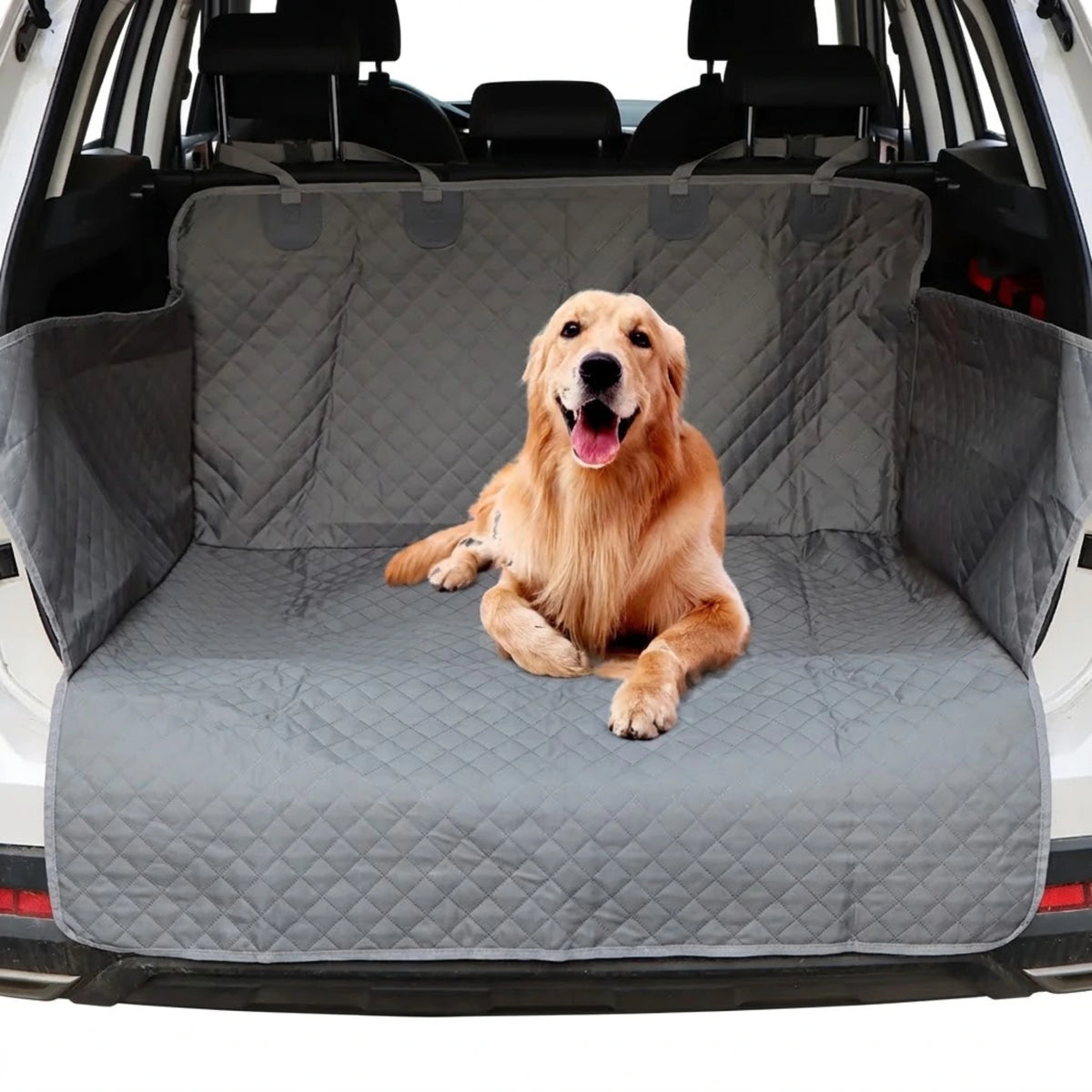 A golden retriever dog lies on a gray quilted car trunk mat inside an SUV, with the rear seats and tailgate visible in the background.