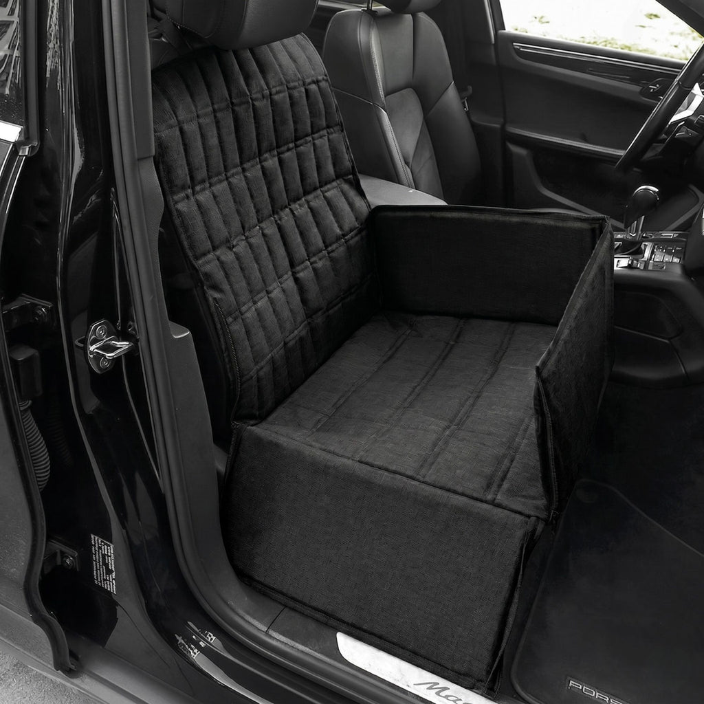 Midnight black pet travel carrier basket installed and secured on the front passenger seat of a vehicle.