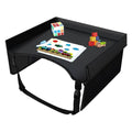 Black kids travel tray holding a rubik's cube, stacking blocks and a colouring page for car trips